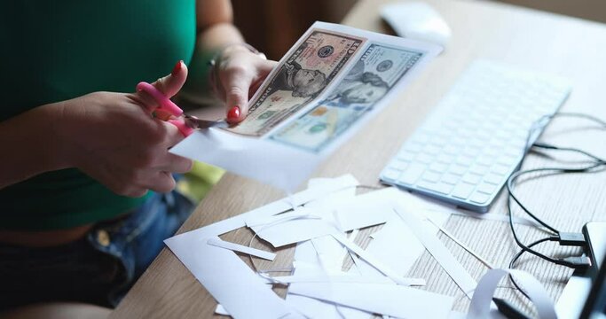 Counterfeiter cuts money printed on printer closeup