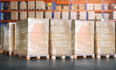 Package Boxes Wrapped Plastic Stacked on Pallets in Storage Warehouse. Supply Chain. Storehouse...