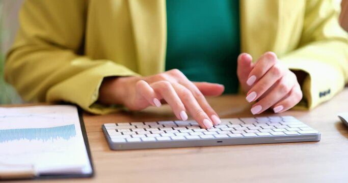 Business woman using laptop computer at desk in workplace