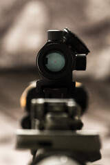 Close-up of flip rear sight and charging handle of assault rifle AR15 khaki camouflage