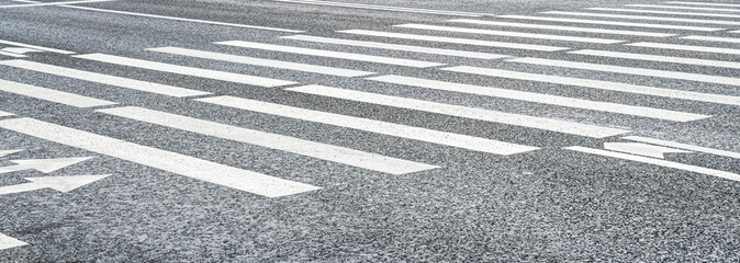 Crosswalk on the road background. Pedestrian crossing on an asphalt road. Crosswalk for safety.