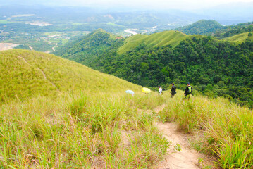 Fototapeta na wymiar Panoramic view of green hill on a sunny summer day. Hiking adventure concept