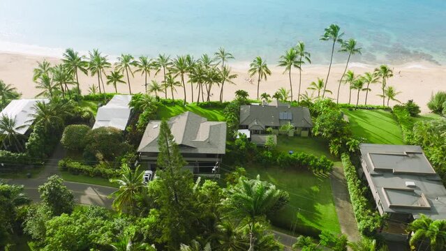 Luxurious beach villa with palm trees and scenic sandy beach. Private house on paradise island. Luxury water front property on Hawaii island. Private luxury beach villa hotel with epic beach view 4K