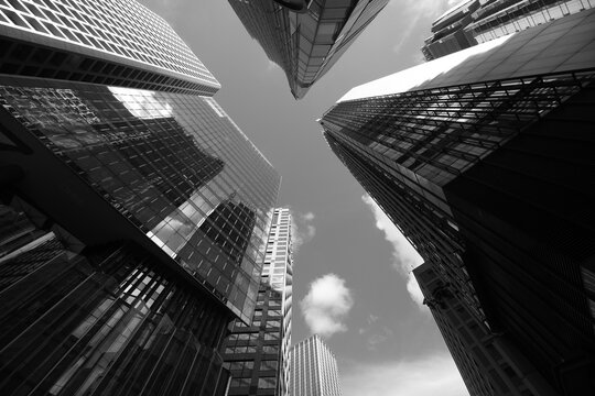 Skyward view of modern skyscrapers in Central, Hong Kong. Black and white photo