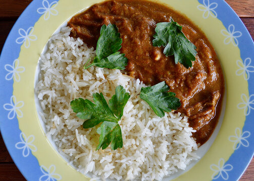 Lamb Rogan Josh Served With Rice And Parsley