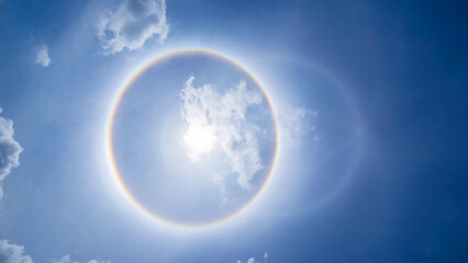 sun corona rainbow clouds and blue sky background , Circumscribed halo