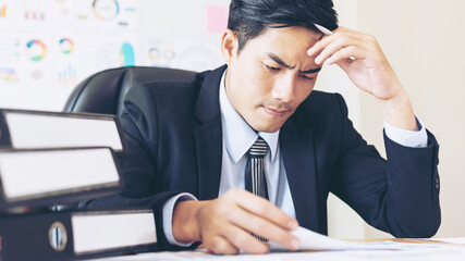 business man is stressed from work , document paperwork on office desk - business concept