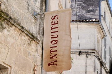 antiquites store entrance panel in the street with retro text antiques in french translation means...