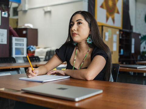 Native girl looks up with a serious face during her class