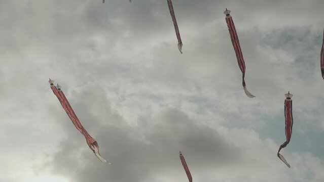 Balinese Traditional Kites JANGGAN (Red White Black Long Tail Bird Dragon) on Bali Kite Festival Summer Blue Sky Slow Motion