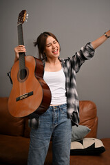 Fototapeta premium Portrait, Attractive hipster young Asian woman holding her classic guitar.