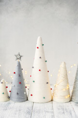 Handmade Christmas trees. Yarn wrapped cone trees and garland. Craft decorations to decorate your home during the holidays
