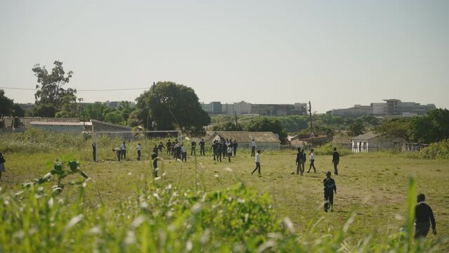 Rural school playing on their sports grounds in hot summer's day in South Africa