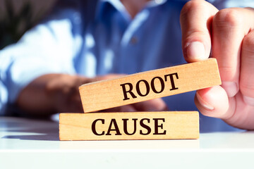 Wooden blocks with words 'Root Cause'. Business concept
