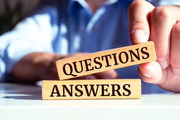 Wooden blocks with words 'QUESTIONS and ANSWERS'.