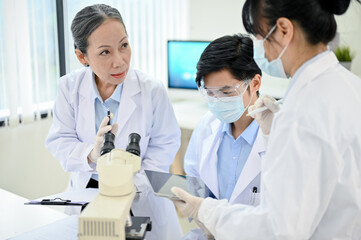 A professional Asian senior female medical specialist training two young junior medical specialist