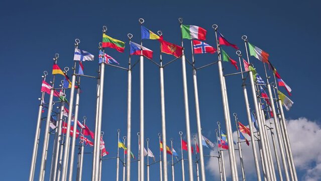 European flags on flagpoles waving with the wind. 4k video footage