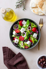 Fototapeta na wymiar Greek salad with feta cheese, tomatoes, cucumbers, peppers and Kalamata olives. Healthy eating. Vegetarian food.