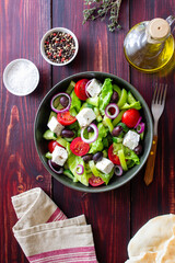Greek salad with feta cheese, tomatoes, cucumbers, peppers and Kalamata olives. Healthy eating. Vegetarian food.