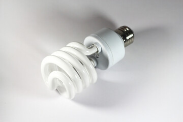 Glowing spiral light bulb isolated on white background. Eco energy saving light bulb concept