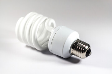Glowing spiral light bulb isolated on white background. Eco energy saving light bulb concept