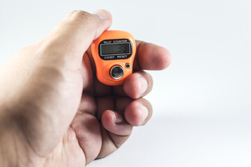 Hand holding numerical tasbih tally counter for islamic people to use for zikr