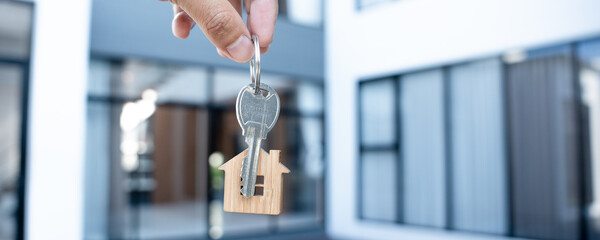 Selling home ,Landlord and New home. The key for unlocking a new house is plugged into the door....