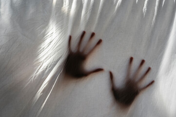Hands shades behind a white sheet of anonymous person. Concept about mental health and illness, isolation, anxiety, stress, imprisonment. - 524201306