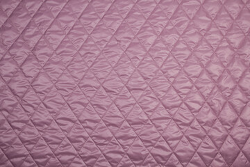 Top view quilted fabric. The texture of the blanket.  Soft quilted blanket as background, top view