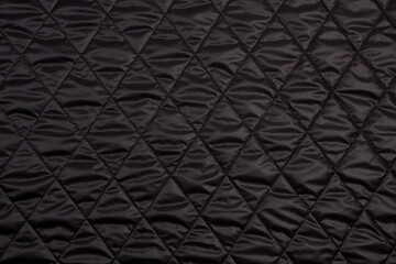 Top view quilted fabric. The texture of the blanket.  Soft quilted blanket as background, top view