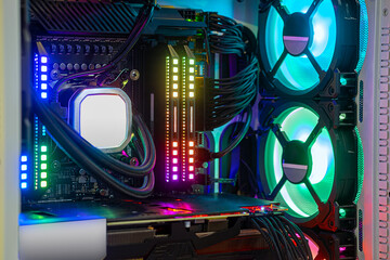 Close-up Hi-performance custom computer desktop for work, play game eSport and entertain on  Metaverse VR with cooling pump installed on CPU processor and multicolored LED neon light show on working