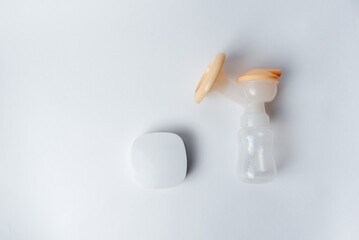 Background of automatic breast pump, baby bottle for milk. Mother's breast milk is the healthiest...