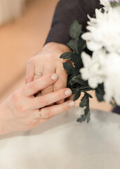 Female and male hand with wedding rings