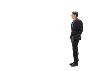 Miniature people businessman wearing black suit standing isolated on white background with clipping...