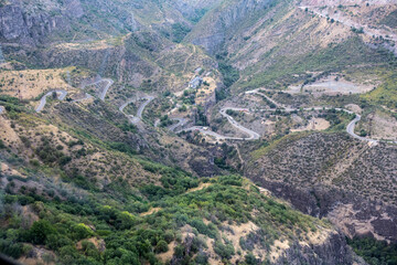 Obraz premium mountain gorge with a steep road and a funicular line in the mountains of Armenia