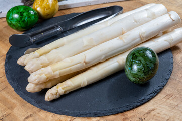 Cooking of fresh white asparagus vegetables, peeler knife for asparagus
