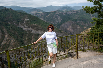 Fototapeta na wymiar woman tourist on the observation deck in a picturesque gorge in the mountains of Armenia