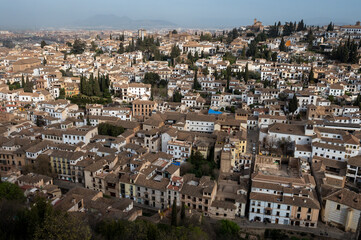 Aerial panoramic view on buildings, old district, mountains and palace, world heritage city Granada, Andalusia, Spain