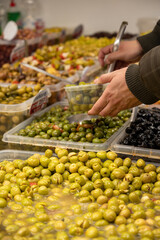 Assortment of pickled green olives for sale on farmers market in Malaga, Andalusia, Spain