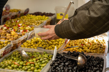 Assortment of pickled green olives for sale on farmers market in Malaga, Andalusia, Spain