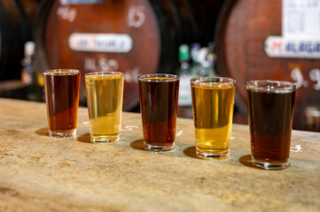 Tasting of different sweet wines from wooden barrels on old bodega in central part of Malaga, Andalusia, Spain