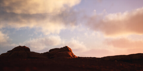 Canyon landscape with sandstone mounds at cloudy sunset. 3D render.