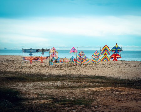 Colourful kites on display for sale at the beach.