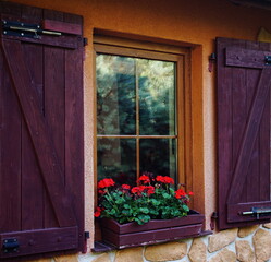 Windows with wooden shutters on the wall of a country house