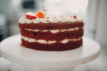 Making delicious red velvet cake. Cooking and decorating dessert with cream cheese, mint and strawberry.