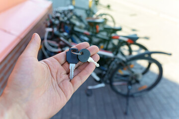 Key is in the hand of the bike. Vehicle protection, selective focus.