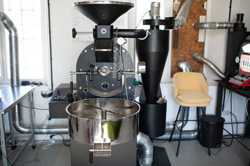 Coffee roaster machine at coffee roasting process.
