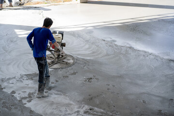 Construction workers use concrete polishers and hard floors.