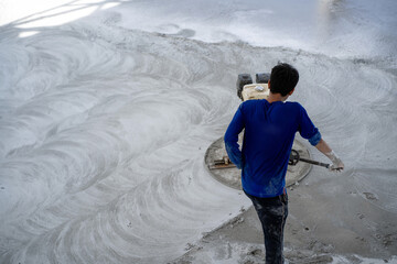 Construction workers use concrete polishers and hard floors.
