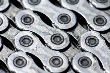 Obraz premium View of Shiny Dirty Greasy Oiled Bicycle Chain As A Part of Metal Bicycle Equipment On Grey Tile Stony Background With Contrast Details